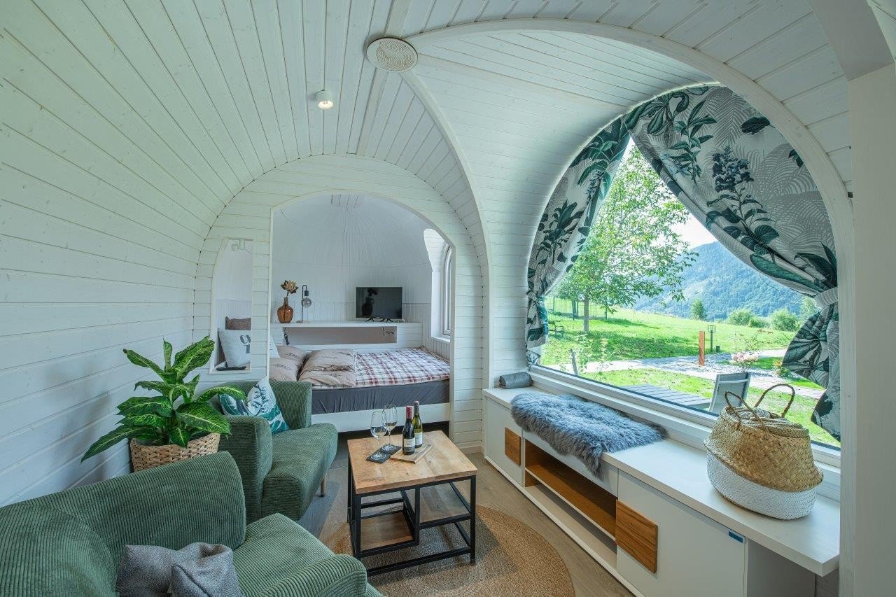 Furnished cabin interior with a mountain view