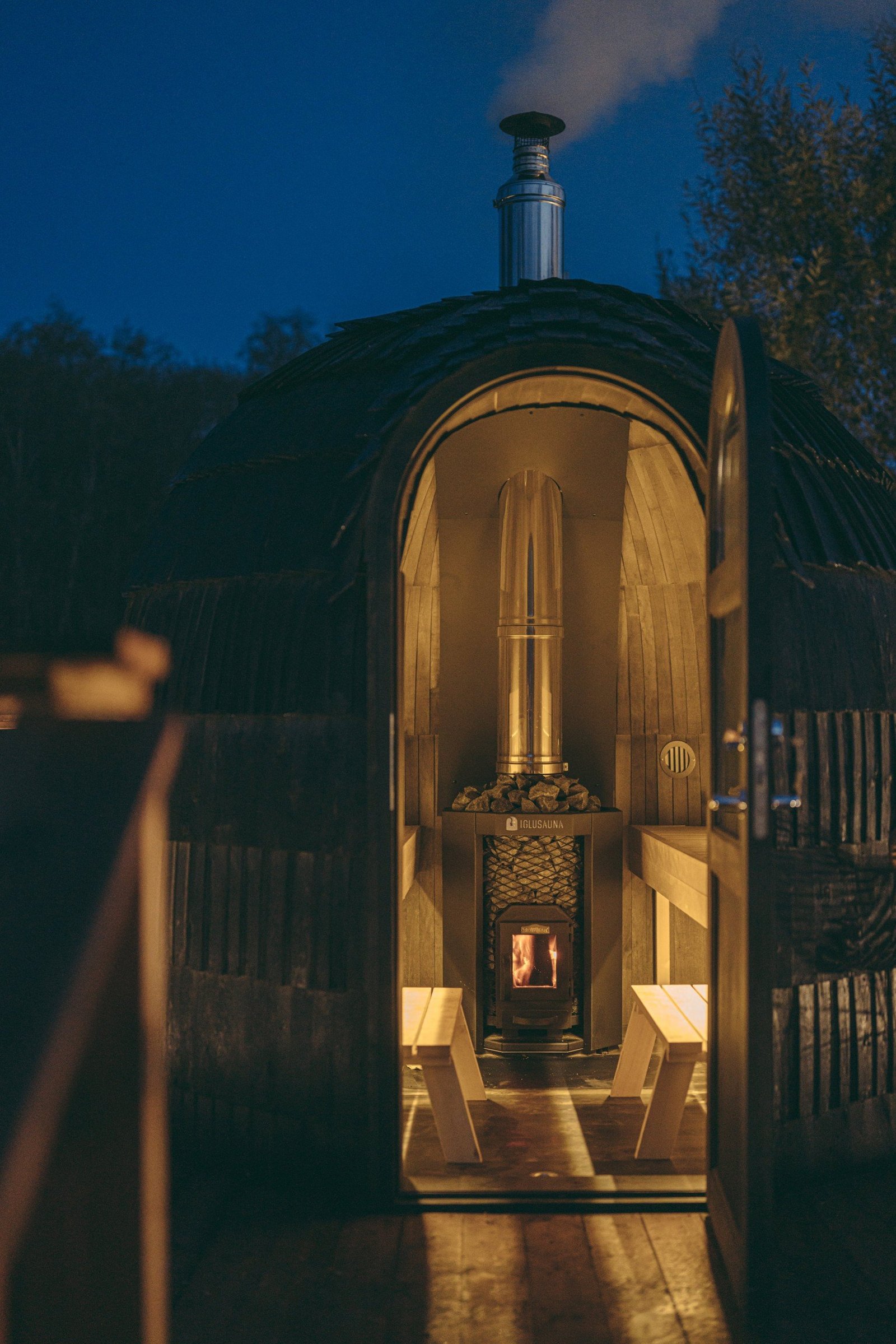 Interior of iglusauna with a smoking chimney