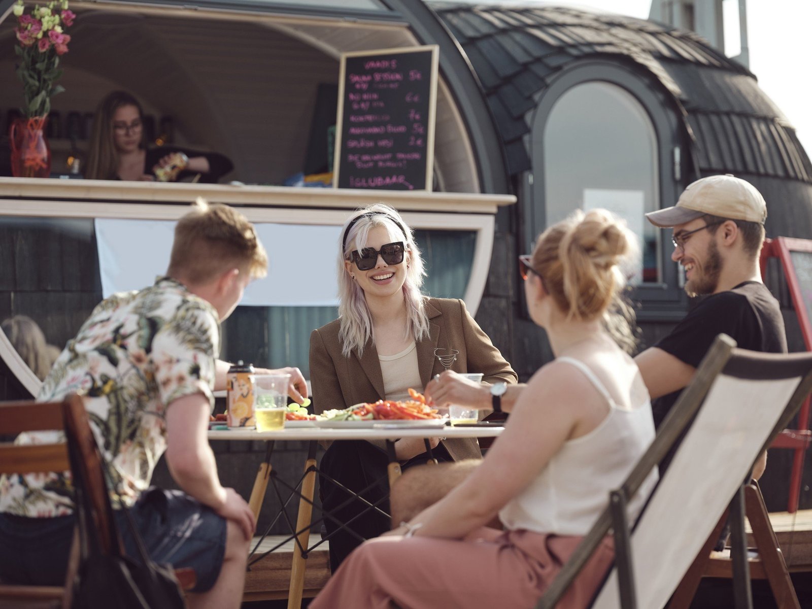 People enjoying food next to a Iglubar