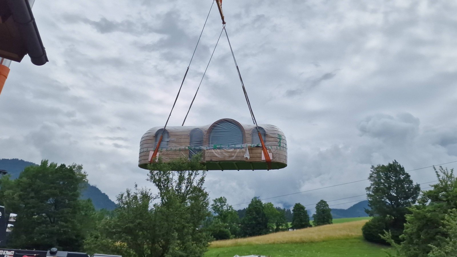 Crane lifting a cabin