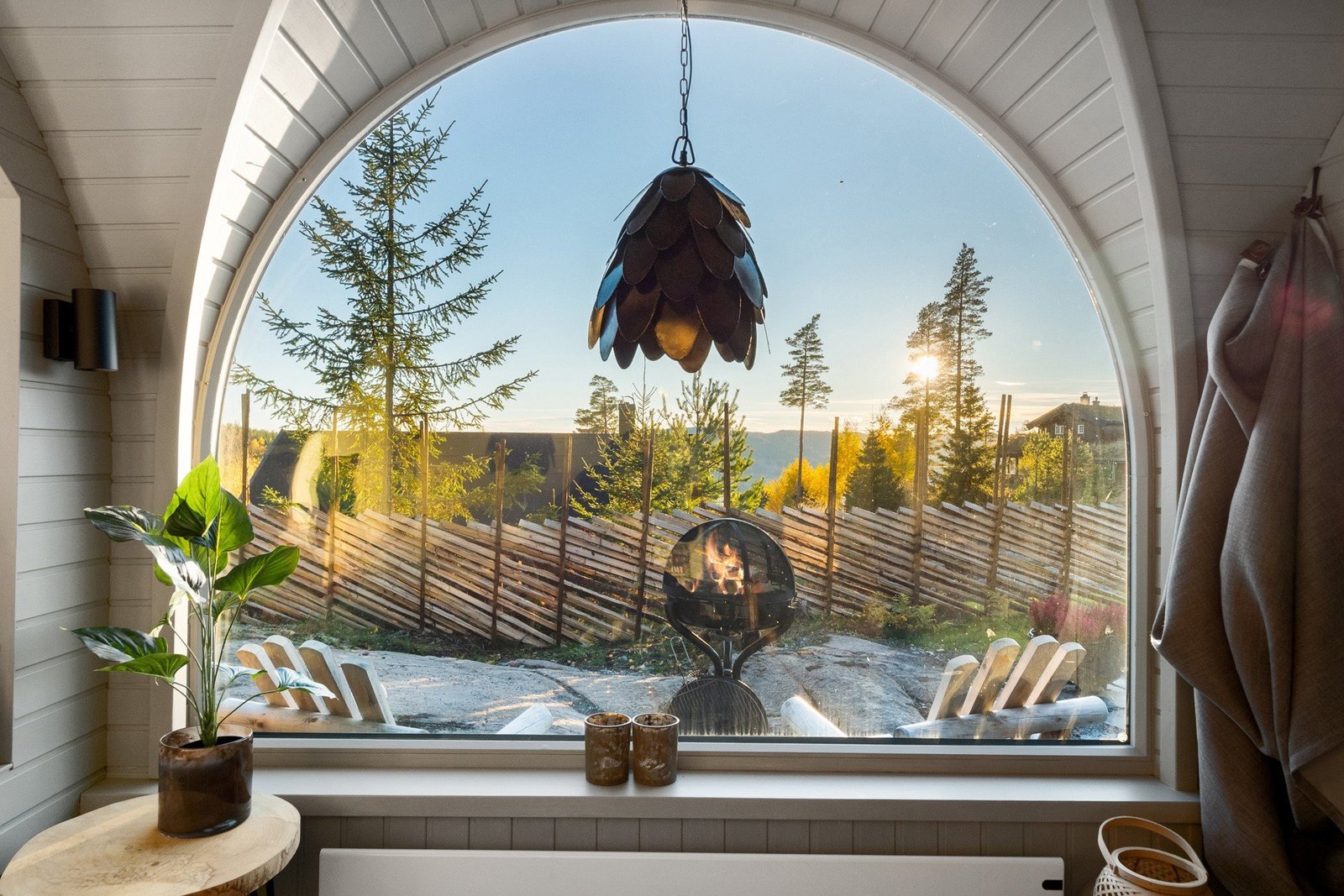 Looking outside of the cabin window at a grill
